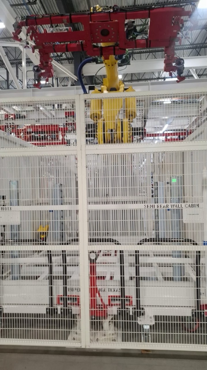 Overhead gripper inside a fenced cell