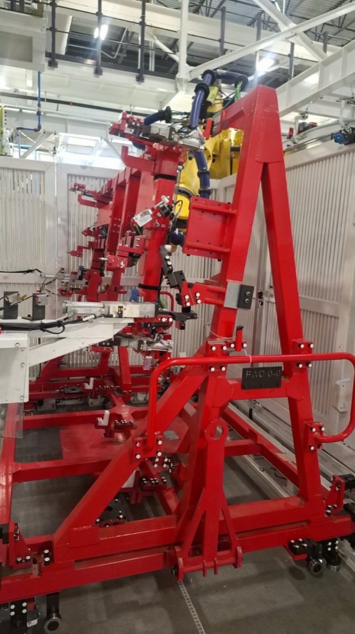 Red fixture with a robot behind it